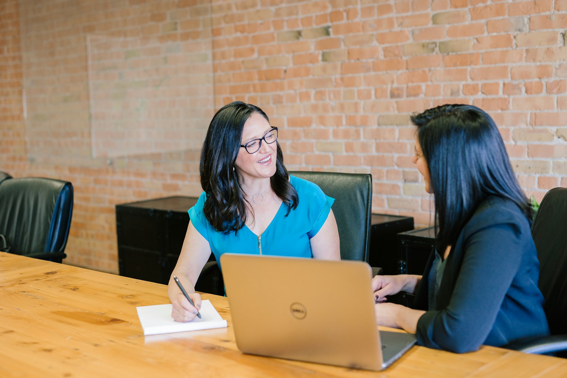A security advisor reviewing strategy with a client in a conference room