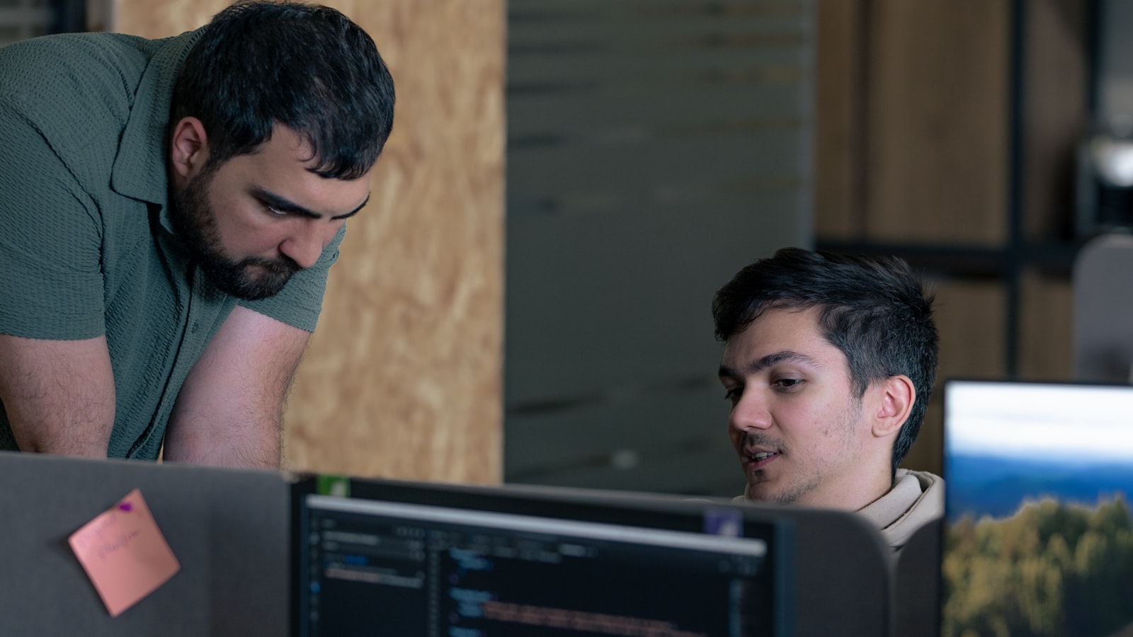 Two engineers manually verifying findings at a workstation during a penetration test